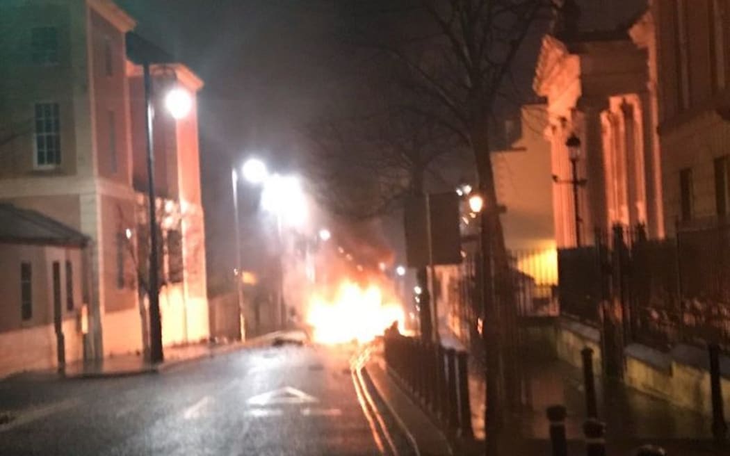 A handout picture taken and released by the Police Service of Northern Ireland on January 19, 2019 shows a burning car following a suspected car bomb in Londonderry, Northern Ireland