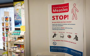 A poster at a medical centre warns against the spread of measles.