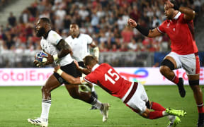 Fiji's inside centre Semi Radradra, left, runs with the ball as Wales' full-back Liam Williams, centre, tries to tackle during the France 2023 Rugby World Cup Pool C match between Wales and Fiji at Stade de Bordeaux in Bordeaux, south-western France on September 10, 2023.