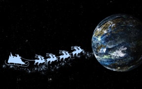 Santa Claus on sleigh with reindeer over the world.