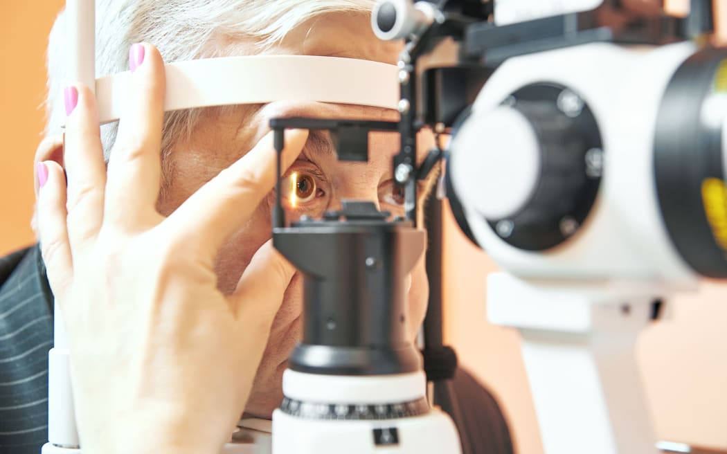 Optometry concept. Male patient under optometrist optician examinination of eyesight in eye ophthalmological clinic