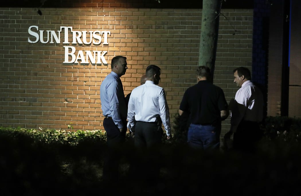 Law enforcement officials investigate the scene where five people were killed at a SunTrust Bank in Sebring, Florida. AFP