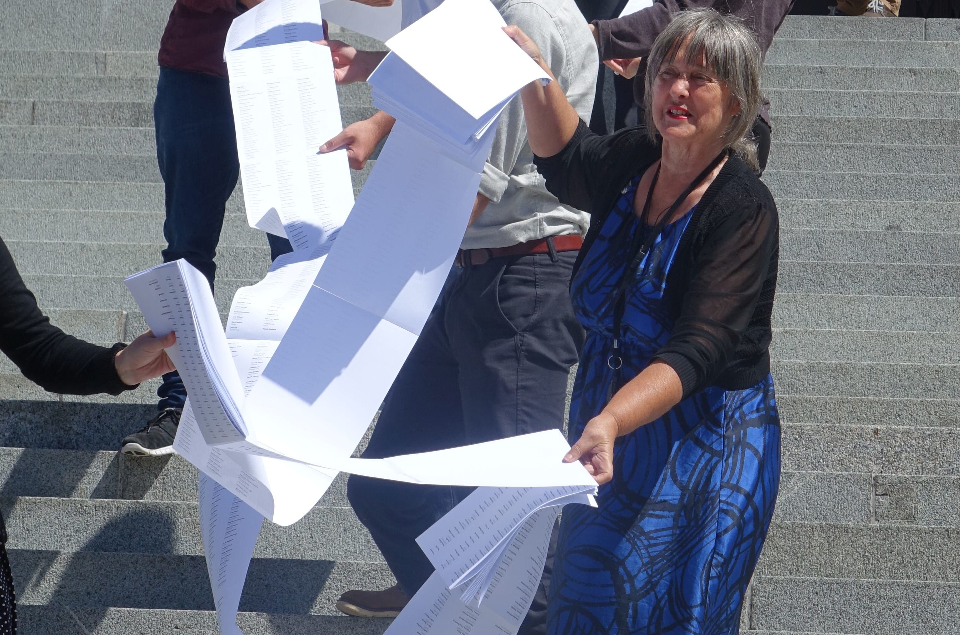 Catherine Delahunty (front) holding part of the list of 12,000 names supporting the call for swimmable freshwater.