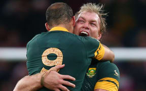 Schalk Burger of South Africa hugs Fourie Du Preez (no.9) as they celebrate their quarter-final win over Wales.