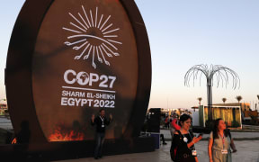 People walk at the green zone of the Sharm el-Sheikh International Convention Centre, during the COP27 climate conference in Egypt's Red Sea resort city of the same name.