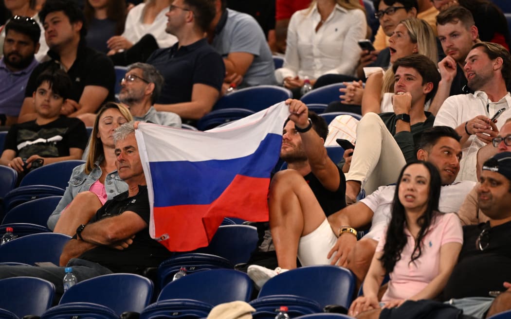 A supporter holds a Russian flag during the match between Marcos Giron (US) and Russia's Daniil Medvedev at the Australian Open on 16 January, 2023, a day before the flags of Russia and Belarus were banned.