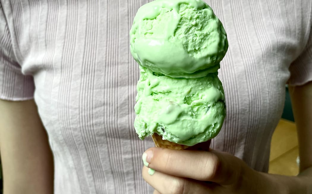 Homemade Goody Jamdrop Ice Cream - Close-up of hand holding a cone with two scoops on top