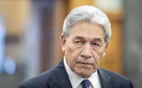 Winston Peters speaks to media on his way to the debating chamber in Parliament, Wellington.