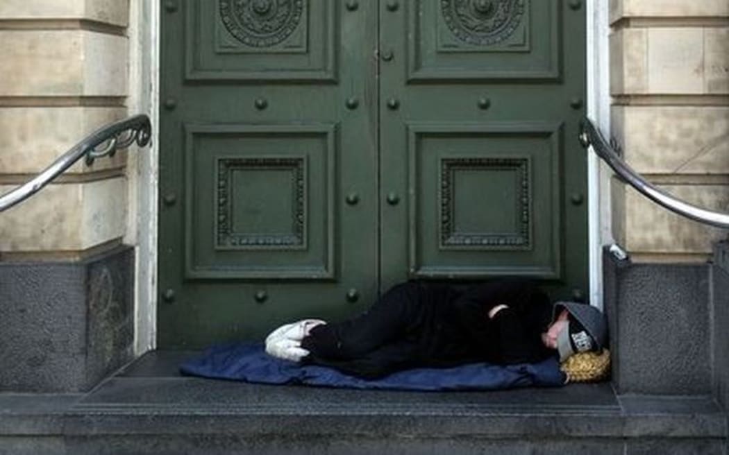 homeless person sleeping in doorway