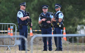 Armed police at the area where graves are being prepared. 20 March 2019