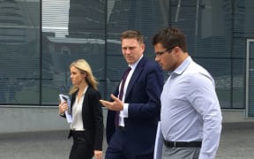 Gable Tostee (right) and lawyer Nick Dore (centre) leaves the Brisbane Supreme Court.