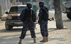 Security forces personnel stand guard  after the bomb attack on the Makal Almukarama hotel in Mogadishu by Somalia's Al-Qaeda-affiliated Shebab militants.