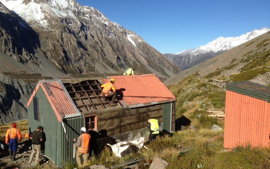 The historic Hooker Hut being removed from its precarious position in Aoraki/Mt Cook National Park.