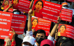 YANGON, MYANMAR - FEBRUARY 20: Anti-coup protesters hold placards as they protest against the military coup Saturday, February 20, 2021, in Yangon, Myanmar. Stringer / Anadolu Agency