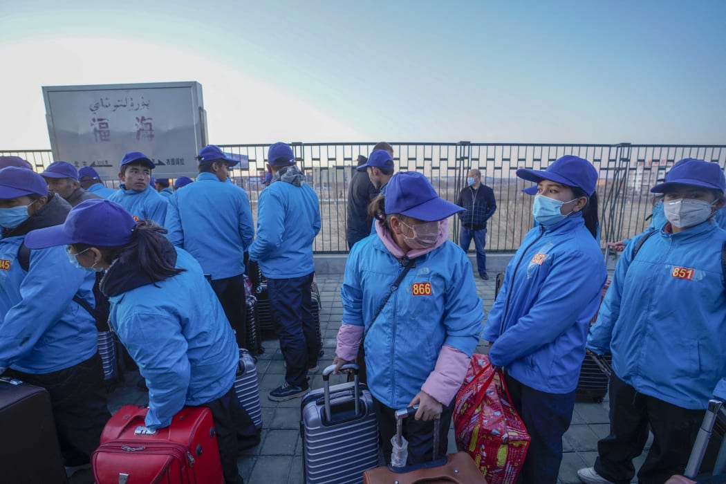 Buzeynep Abulehet (second from right) arrives at Fuhai County by train, in northwest China's Xinjiang Uygur Autonomous Region, March 28, 2020.