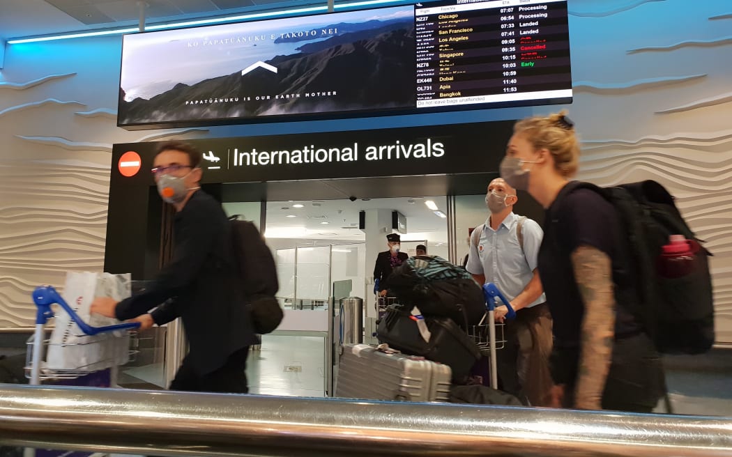 Travellers with face masks at Auckland Airport international arrivals during the Covid-19 coronavirus outbreak on 20/3/2020.