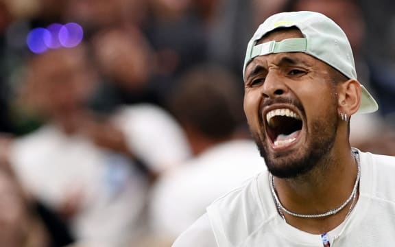 Australian Nick Kyrgios celebrates the defeat of Greek Stefanos Tsitsipas during their men's singles tennis match on the sixth day of the 2022 Wimbledon Championship at The All England Tennis Club in Wimbledon, south-west London, on July 2, 2022. ( Photo of Glyn KIRK / AFP) / RESTRICTED FOR EDITORIAL USE