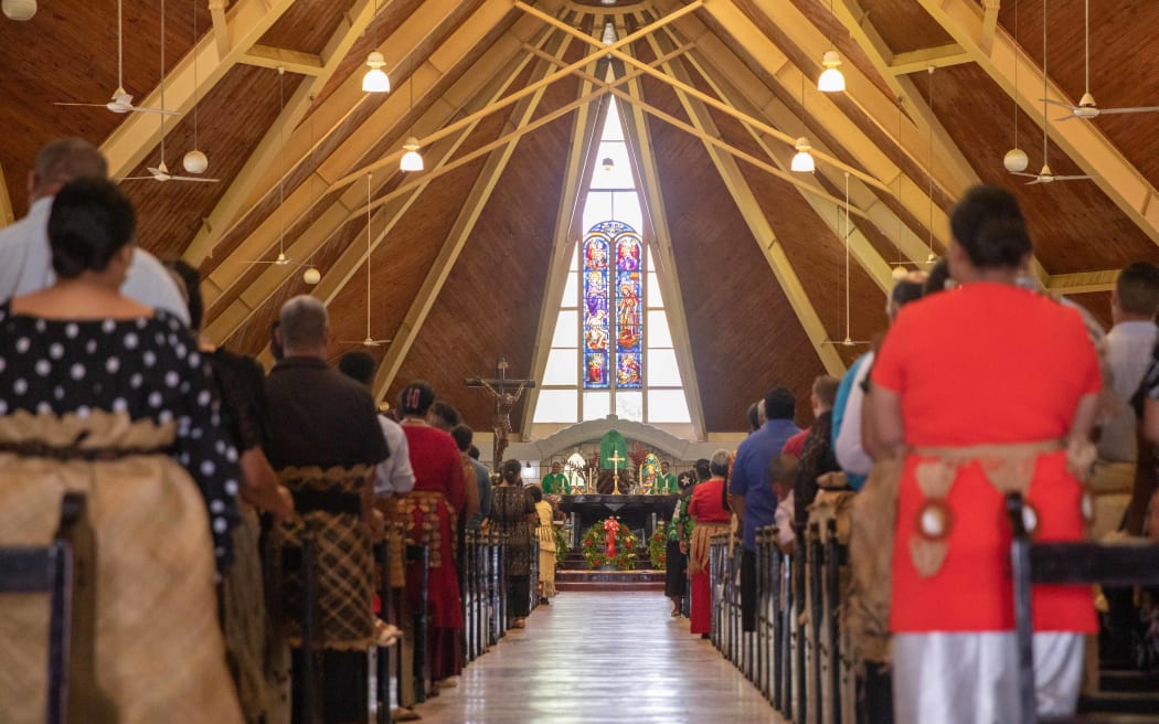 Tongan's gather at St Mary's Cathedral in Nukualofa to commemorate the one year anniversary of the eruption and tsunami.