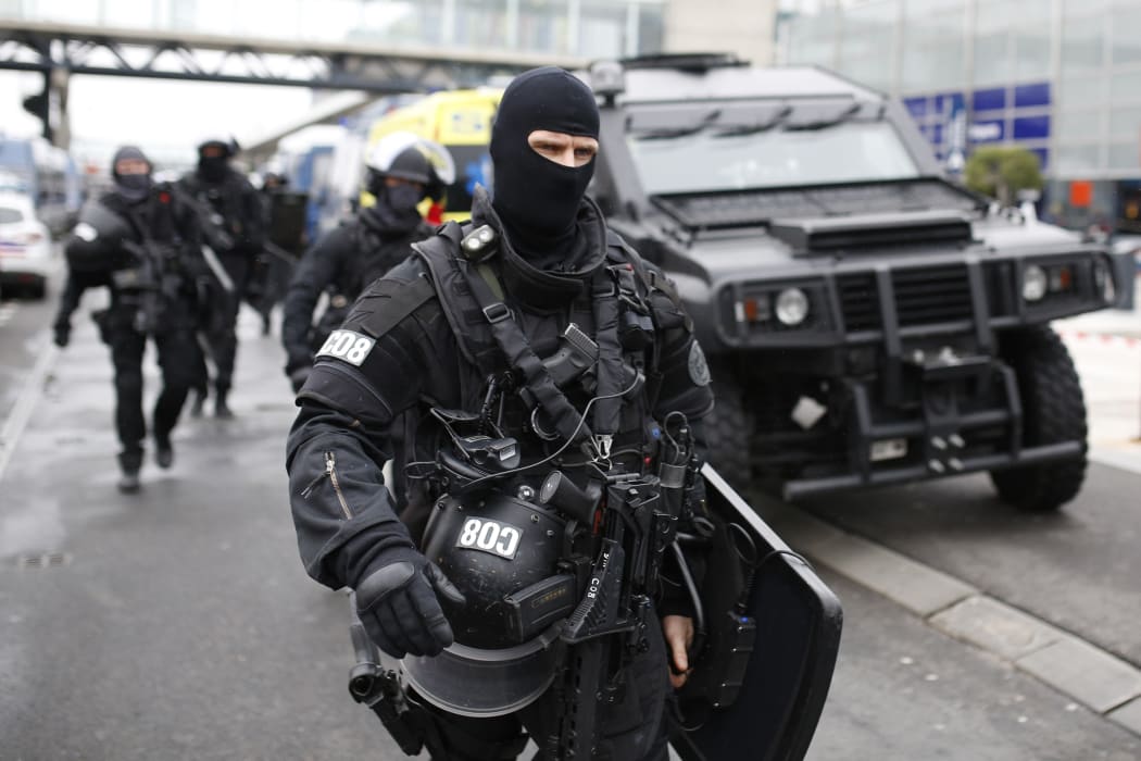 RAID police unit officers secure the area at the Paris' Orly airport on 18 March, 2017 following the shooting of a man by French security forces.