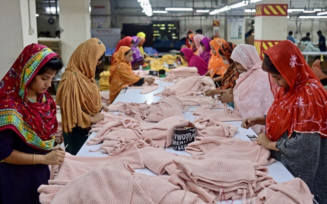 In this photograph taken on April 13, 2023, women work at a garment factory in Savar, on the outskirts of Dhaka. - The tenth anniversary of the Rana Plaza garment building collapse will be marked on April 24, a catastrophe that spotlighted the global fashion industry's reliance on developing world labour, working in dangerous and sometimes deadly conditions. (Photo by Munir uz ZAMAN / AFP) / To go with 'BANGLADESH-ACCIDENT-LABOUR-TEXTILE,FOCUS' by Shafiqul ALAM
