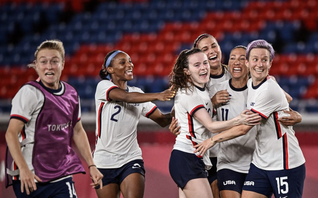 USA's forward Megan Rapinoe (R) and teammates celebrate after winning the Tokyo 2020 Olympic Games women's quarter-final football match between Netherlands and the USA at Yokohama International Stadium in Yokohama on July 30, 2021.