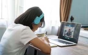 Girl studying homework online lesson at home, distance learning.