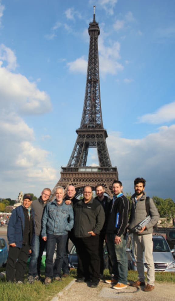 Joseph Bertolozzi with musicians in front of the Eiffel Tower