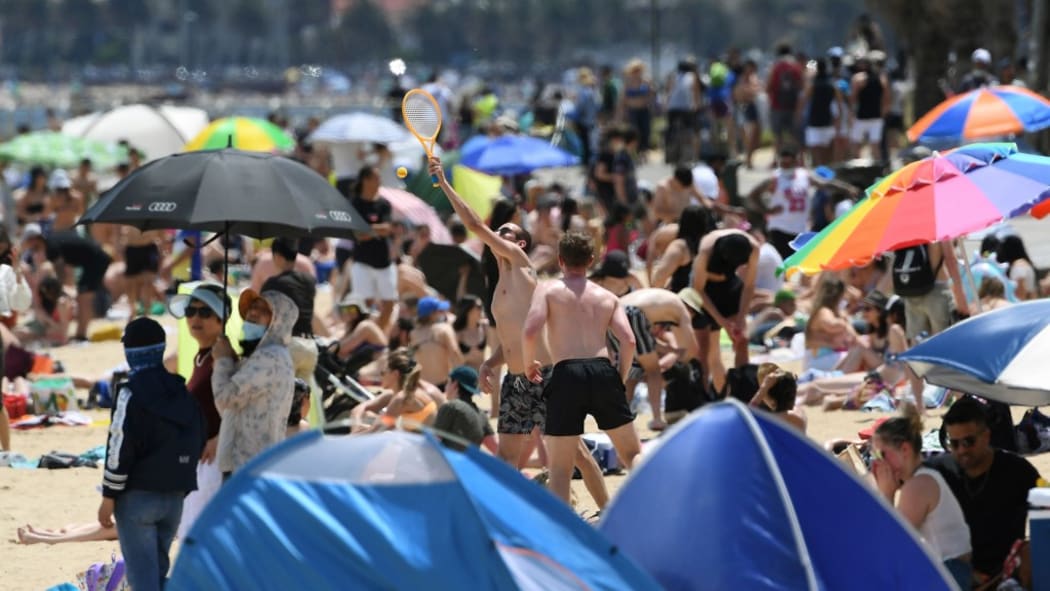 People enjoy the warm weather on Melbourne's St Kilda Beach on November 3, 2020, as Australia's Victoria state records its fourth straight day of zero transmissions of the COVID-19 coronavirus after battling a second wave of infections.