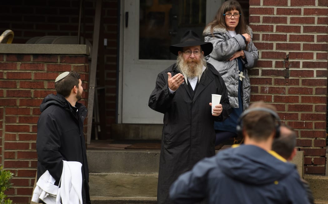 Residents talk to the media near the site of a mass shooting at the Tree of Life Synagogue in the Squirrel Hill neighborhood on October 27, 2018 in Pittsburgh, Pennsylvania.