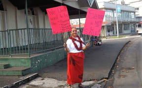A woman protests against Samoa's land laws in Apia on Saturday.