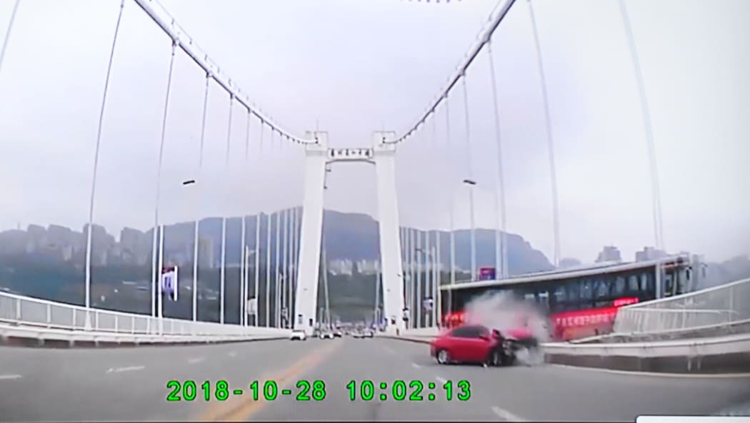 In this screen shot, a bus crashed with a car and plunged into the Yangtze River from a bridge in Wanzhou district