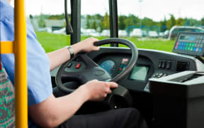 10718109 - bus driver sitting in his bus on tour