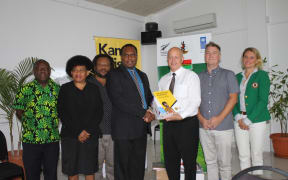 New Zealand High Commissioner to Vanuatu Jonathan Schwass handing over equipment to Cabinet Minister Andrew Napuat