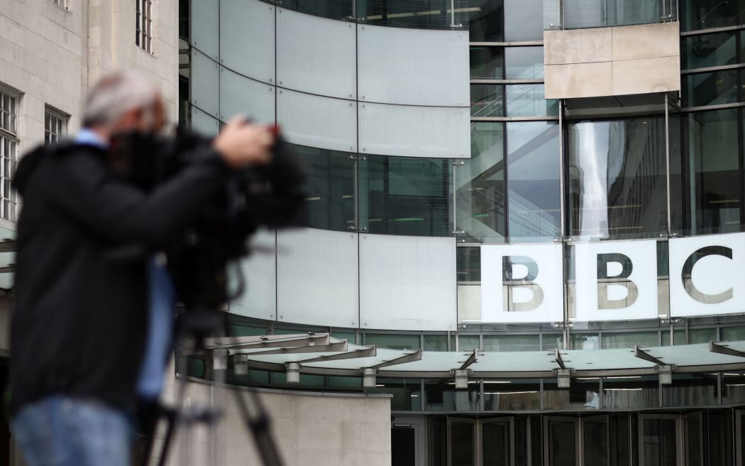 A member of the media works outside BBC Broadcasting House in central London on July 9, 2023 (Photo by HENRY NICHOLLS / AFP)