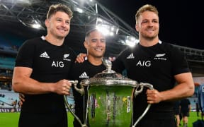 Beauden Barrett, Aaron Smith and Sam Cane pose with the Bledisloe Cup after beating the Wallabies in the third test at ANZ Stadium, Sydney, Australia.