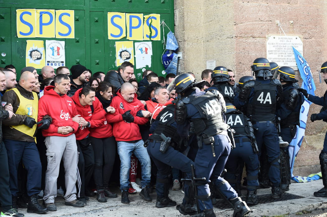 Riot police clash with striking prison guards blocking the access to the Baumettes prison on Monday 22 January in Marseille.