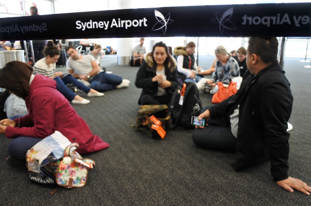 Passengers wait for a delayed flight at Sydney Airport.