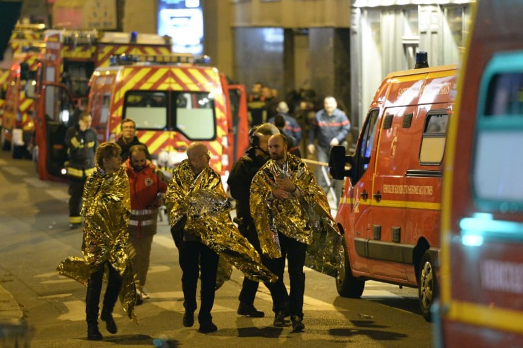People are being evacuated on rue Oberkampf near the Bataclan concert hall in central Paris