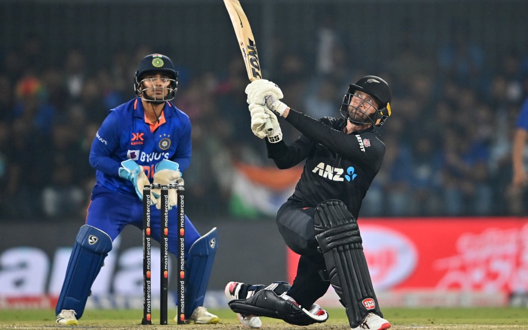 New Zealand's Devon Conway (R) plays a shot as India's wicketkeeper Ishan Kishan watches during the third and final one-day international (ODI) cricket match between India and New Zealand at the Holkar Cricket Stadium in Indore on January 24, 2023. (Photo by Punit PARANJPE / AFP) / ----IMAGE RESTRICTED TO EDITORIAL USE - STRICTLY NO COMMERCIAL USE-----
