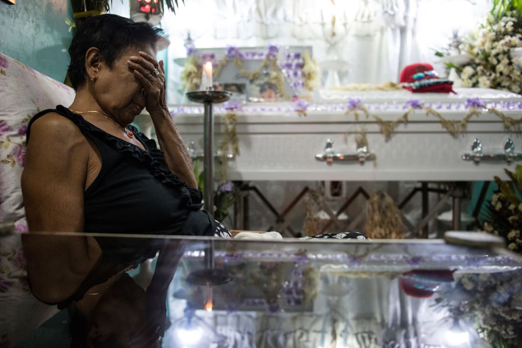 January 24, 2017: A relative at the wake of an alleged drug user killed by unidentified gunmen in Manila. Philippine police may have committed crimes against humanity by killing thousands of alleged drug offenders or paying others to murder as part of President Rodrigo Duterte's drug war.