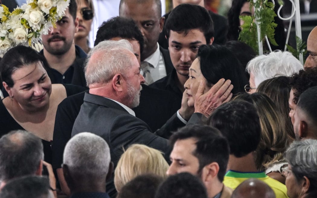 Brazil's President Luiz Inacio Lula da Silva (left) greets the wife of Brazilian football legend Pele, Marcia Aoki (right), during his wake at the Urbano Caldeira stadium in Santos, Sao Paulo state, Brazil on January 3, 2023.