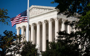 The American flag flies at half staff for late US Supreme Court Justice Ruth Bader Ginsberg outside the US Supreme Court in Washington, DC
