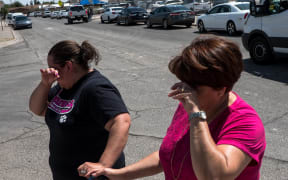 Residents Erica Rios, 36, and Alma Rios, 61, cry outside a reunification center at MacArthur Elementary School, following a deadly mass shooting, in El Paso, Texas, on August 3, 2019.