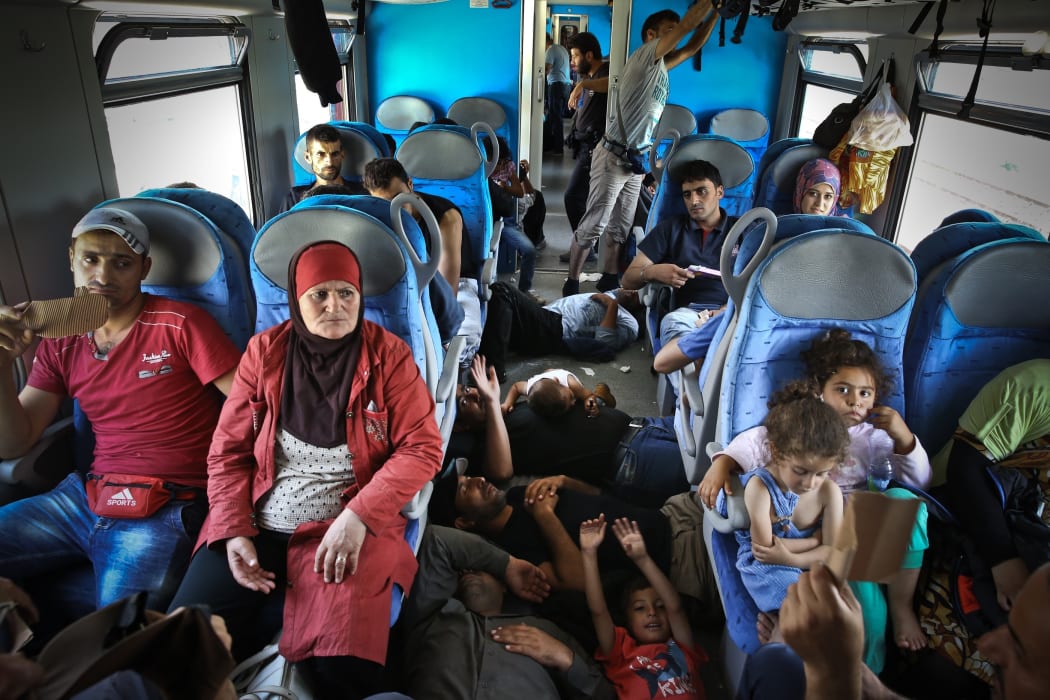Refugees wait inside the train that will bring them to the capital Zagreb in Osijek, near Hungarian border in Croatia