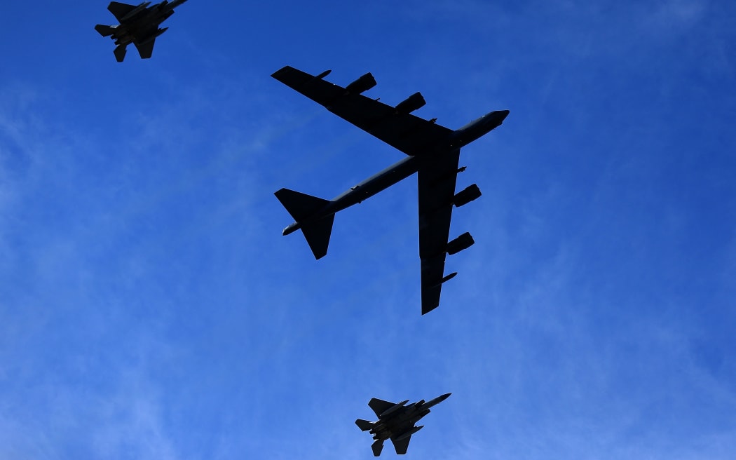 A US B-52 bomber is escorted by two F-15 fighter aircraft during a fly-over at a sports game in Louisiana, on 16 October 2021.