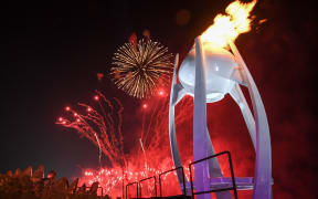 The Olympic flame is lit to a background of fireworks at the Pyeongchang 2018 Winter Olympic Games opening ceremony.