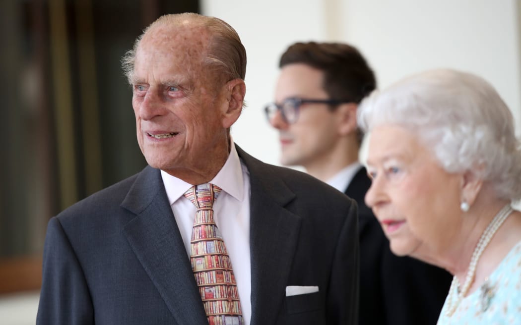 Britain's Queen Elizabeth II (R) and Britain's Prince Philip, Duke of Edinburgh are pictured after greeting Spanish King Felipe VI and Queen Letizia (unseen) at Buckingham Palace in central London on July 14, 2017,