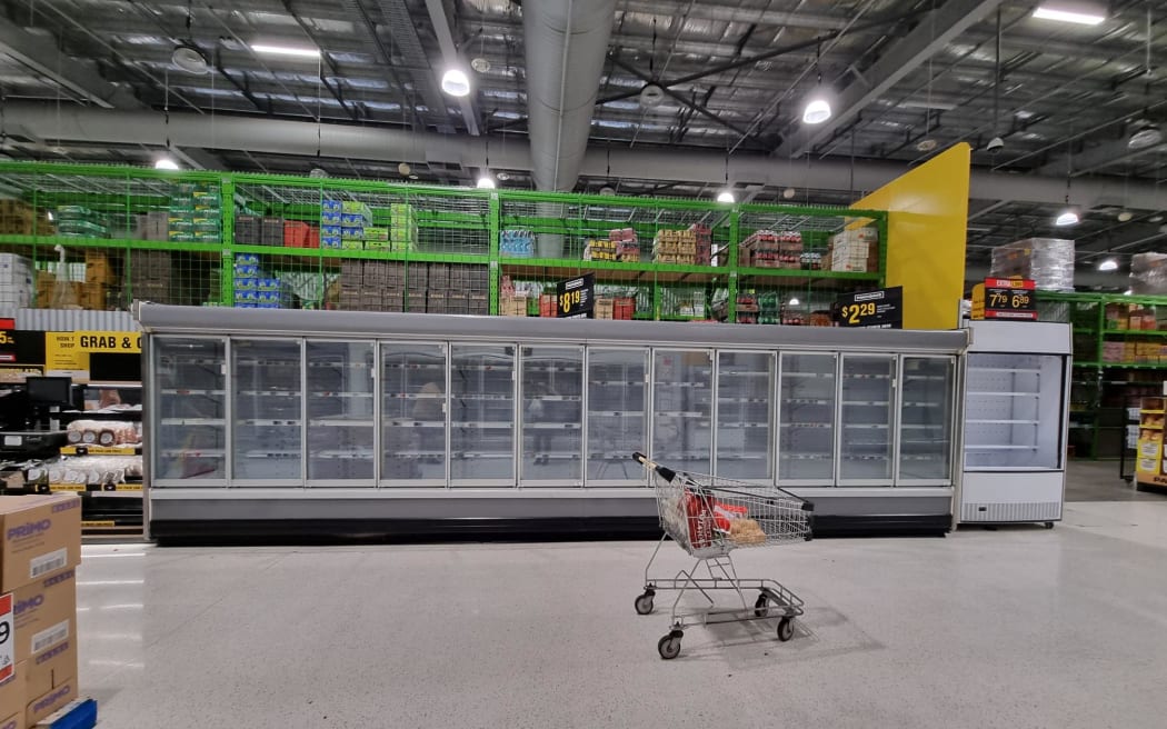 A shortage of supplies is evident, with empty shelves at Pak'nSave in Napier. Queues to get in stretched around the street, with the supermarket limiting the number of people inside at a time.