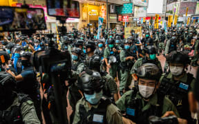 Riot police clear a street as protesters gathered to rally against a new national security law in Hong Kong on July 1, 2020, on the 23rd anniversary of the city's handover from Britain to China.