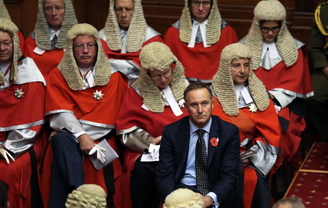 Prime Minister John Key sits in front of the High court judiciary during the official opening of Parliament